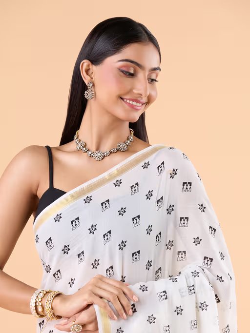 VISCOUS SAREE WITH BLACK DOTS DESIGNS AND GOLDEN BORDER FRAME