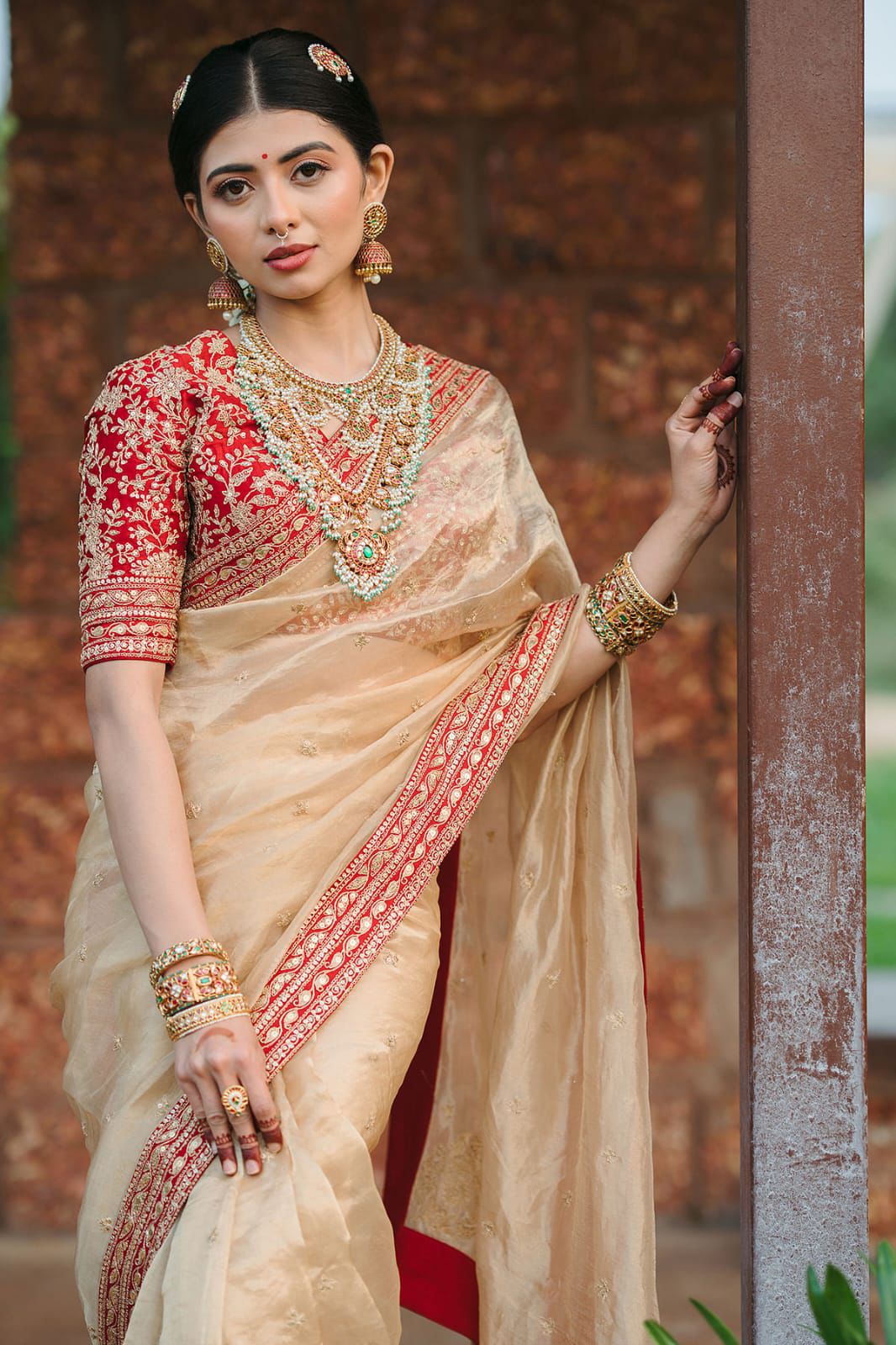 Beige Silk Saree with Red Embroidered Border & Contrasting Blouse.