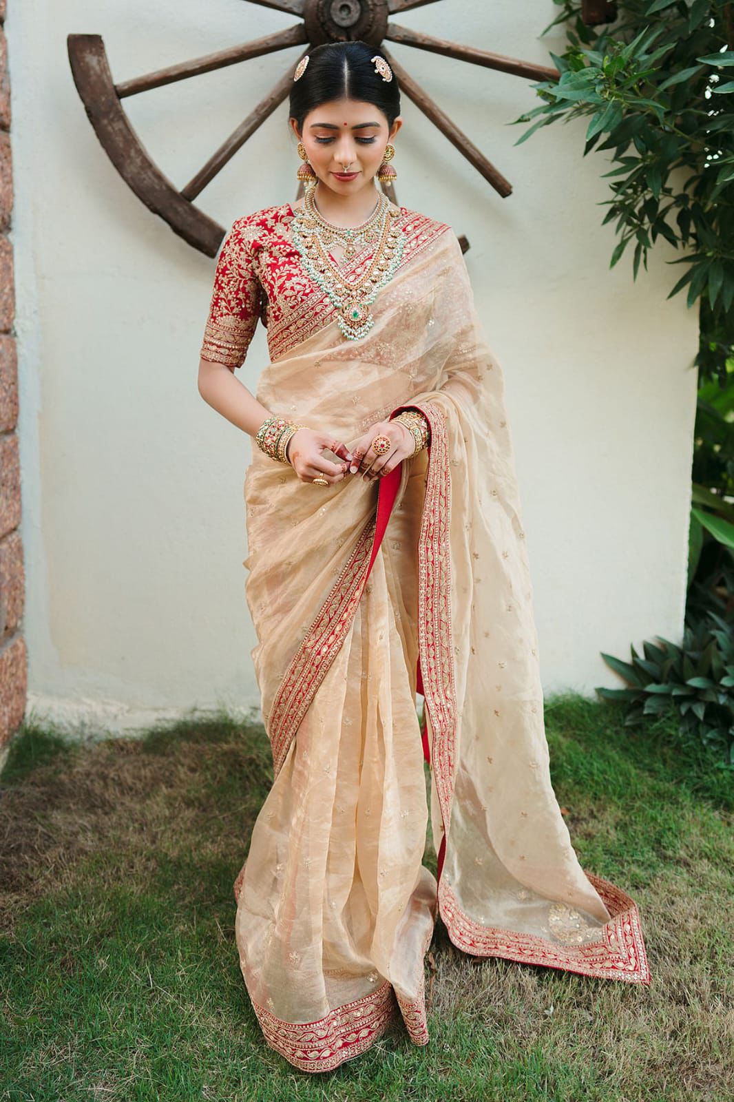 Beige Silk Saree with Red Embroidered Border & Contrasting Blouse.