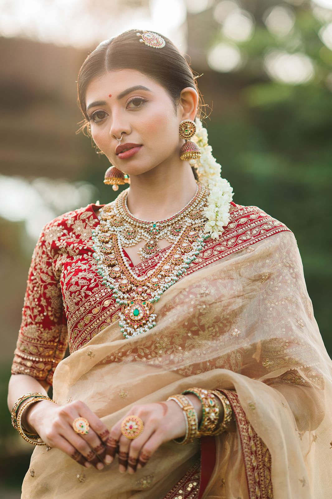 Beige Silk Saree with Red Embroidered Border & Contrasting Blouse.