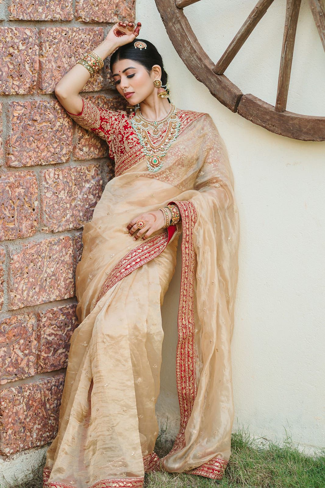 Beige Silk Saree with Red Embroidered Border & Contrasting Blouse.