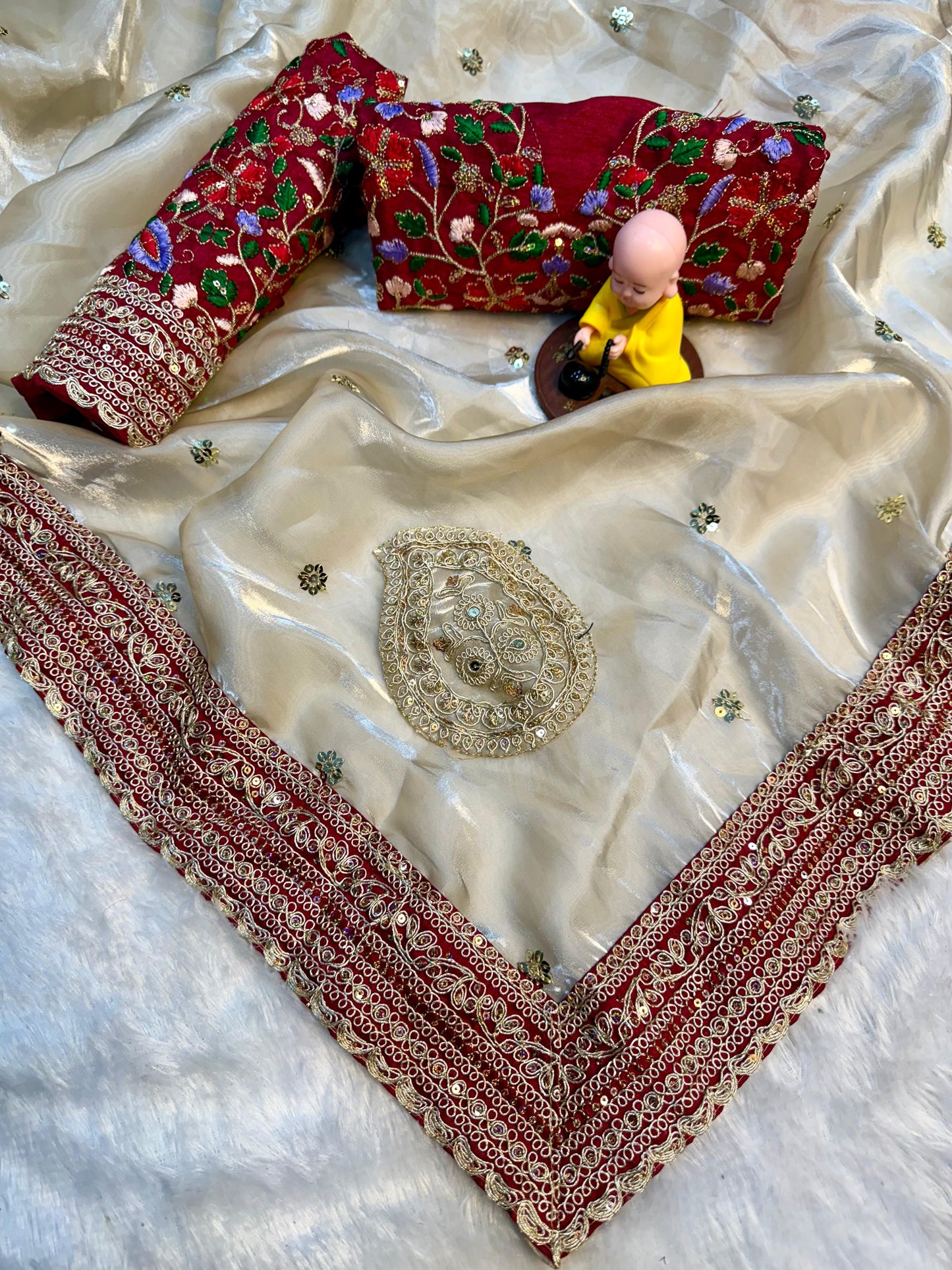 Beige Silk Saree with Red Embroidered Border & Contrasting Blouse.
