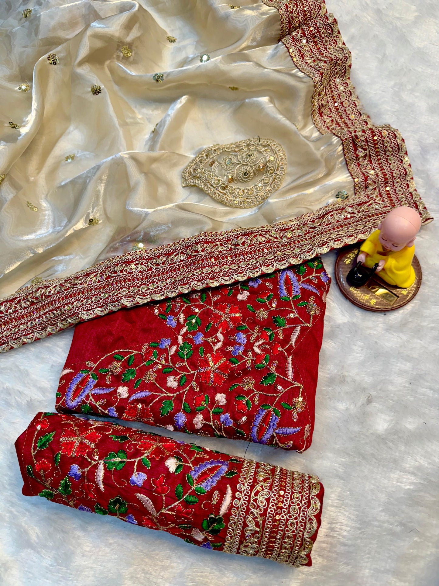 Beige Silk Saree with Red Embroidered Border & Contrasting Blouse.