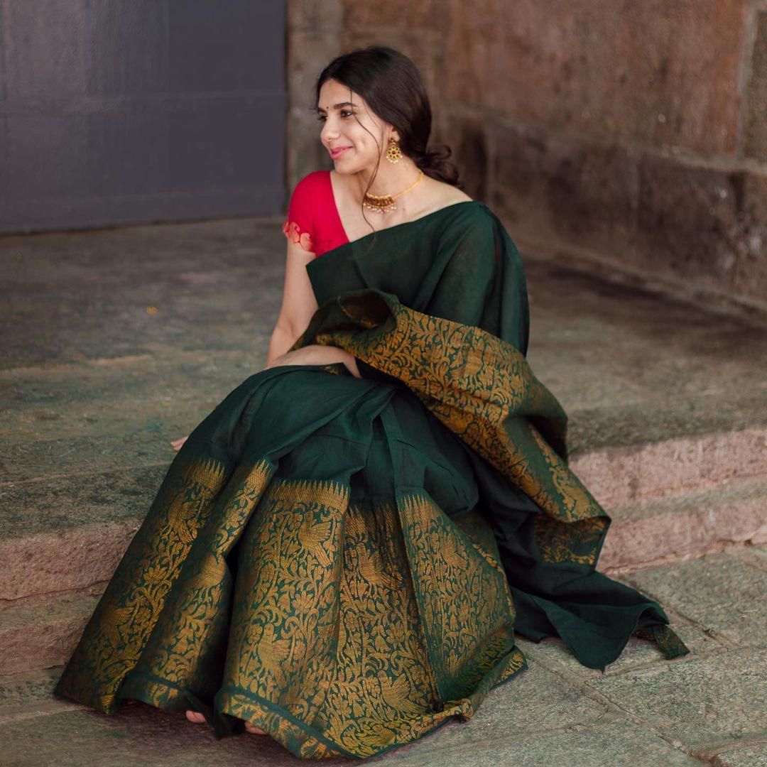 Dark Green Litchi Silk Saree with Red Jacquard Blouse.