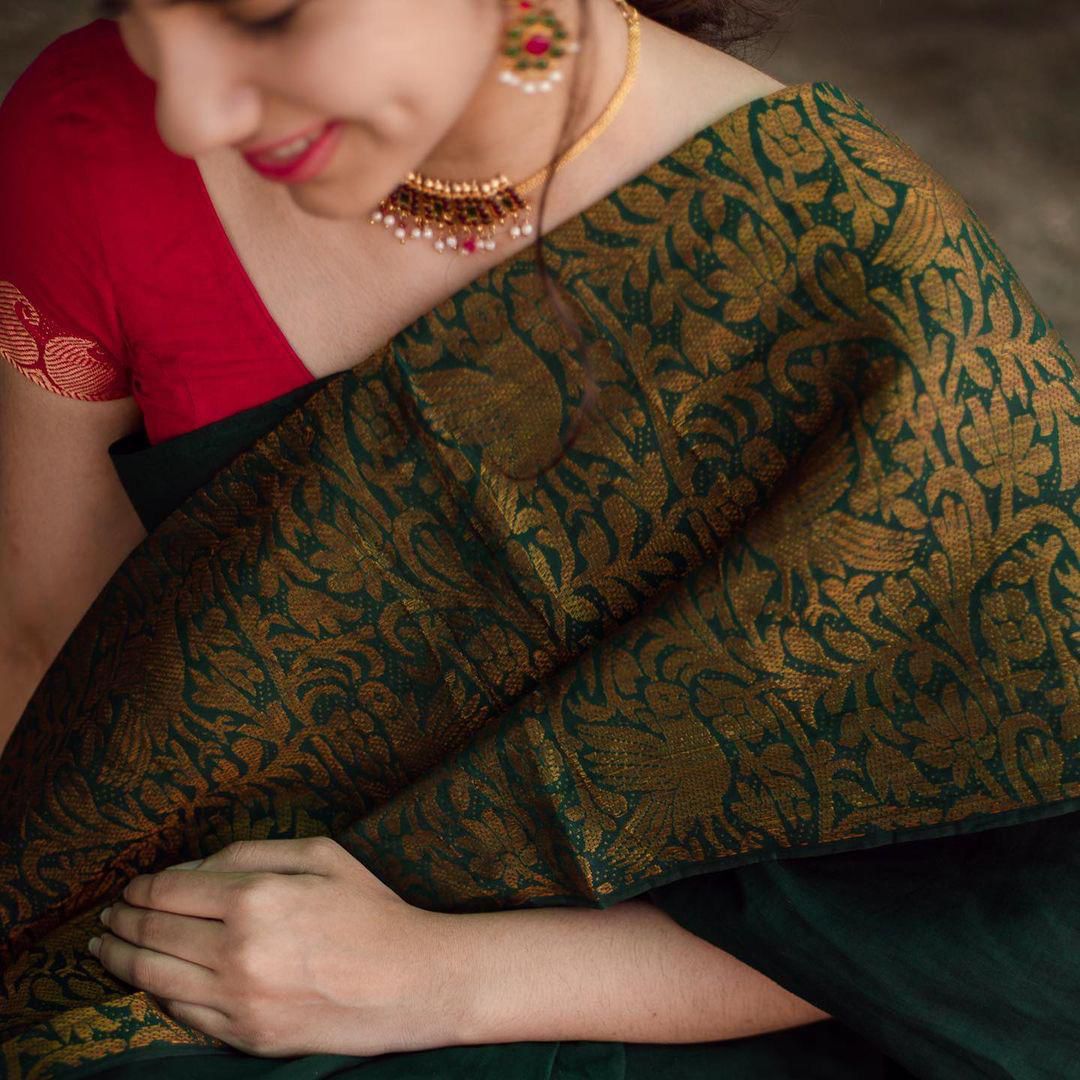 Dark Green Litchi Silk Saree with Red Jacquard Blouse.